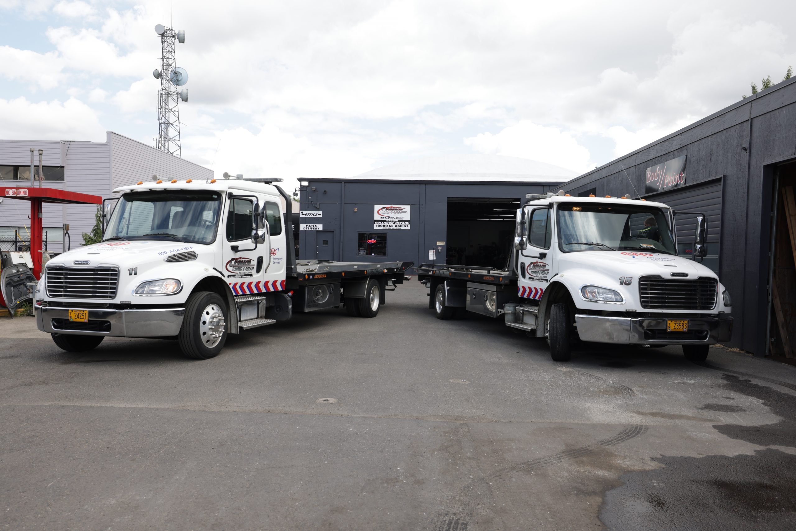 Crown flatbed tow truck loading a customer vehicle on a roadside call
